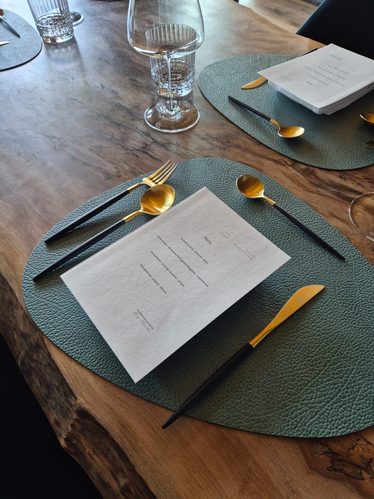 Menu and place setting in a chalet, with gold cutlery