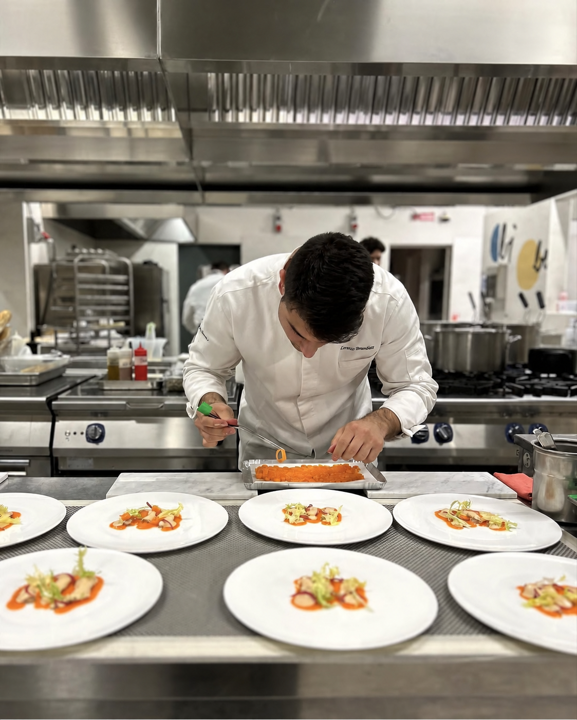 Lorenzo Brancaleon finishing dishes at the kitchen pass