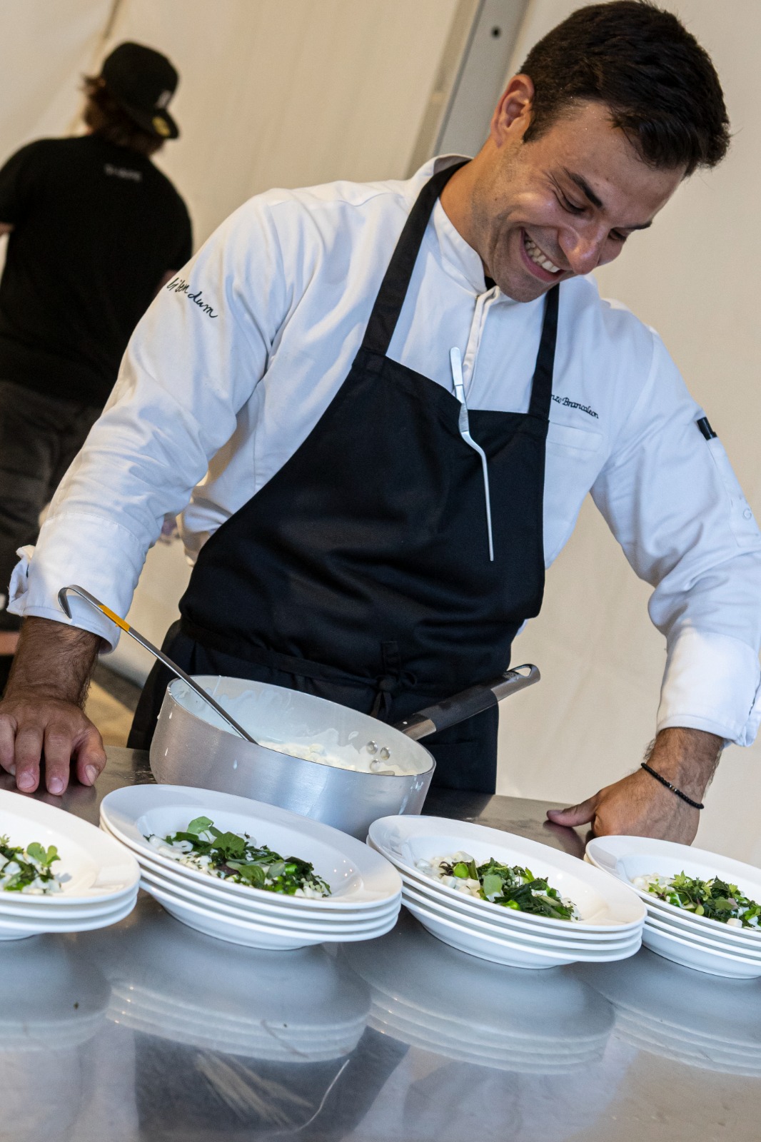 Lorenzo smiling during service, with the dishes ready