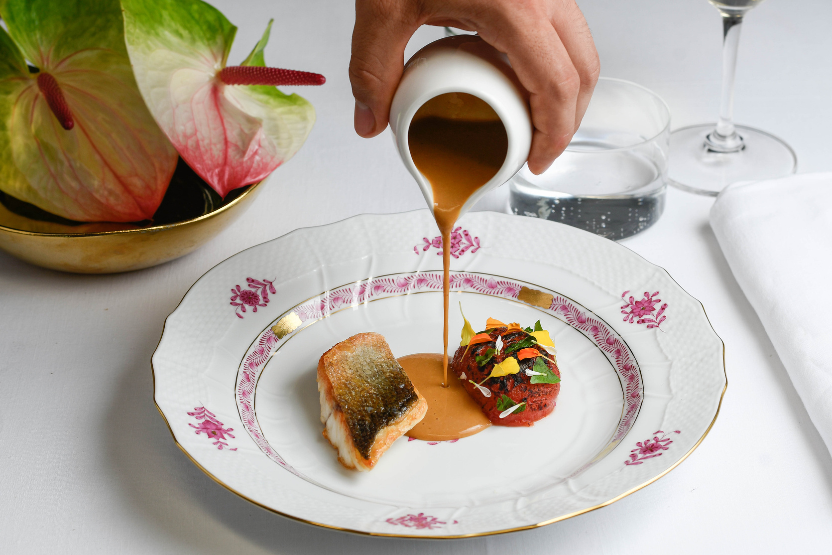 A dish by Lorenzo receiving its finishing touch during service