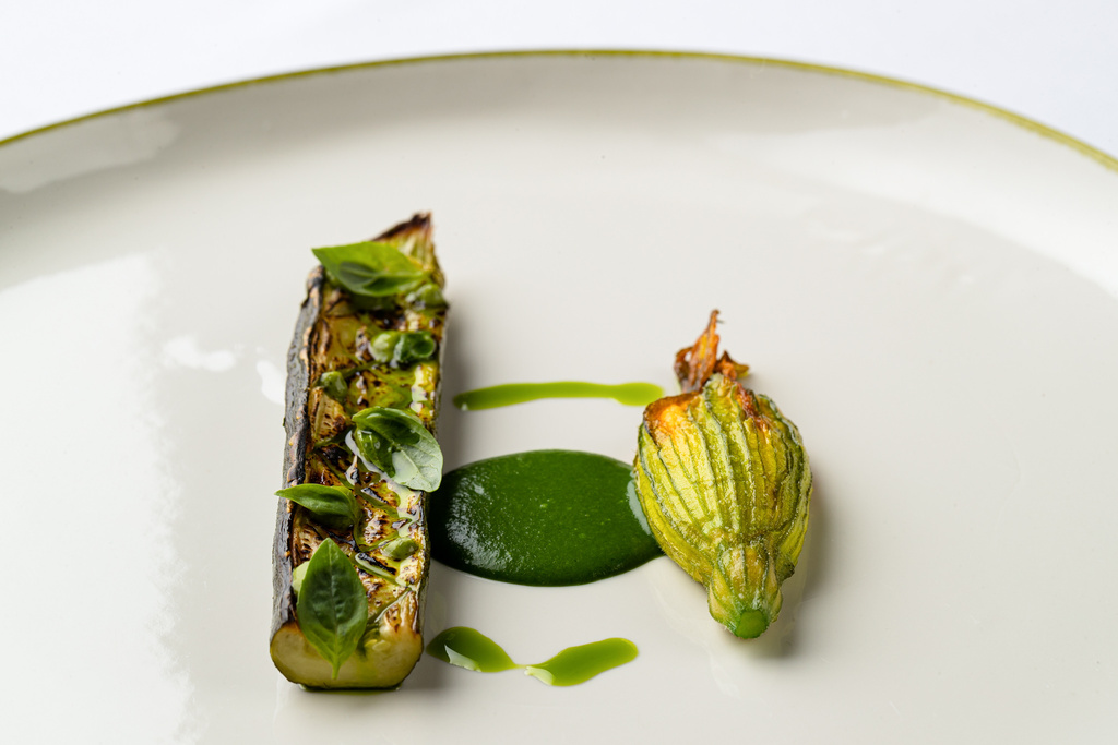 A composition of vegetables and courgette flowers