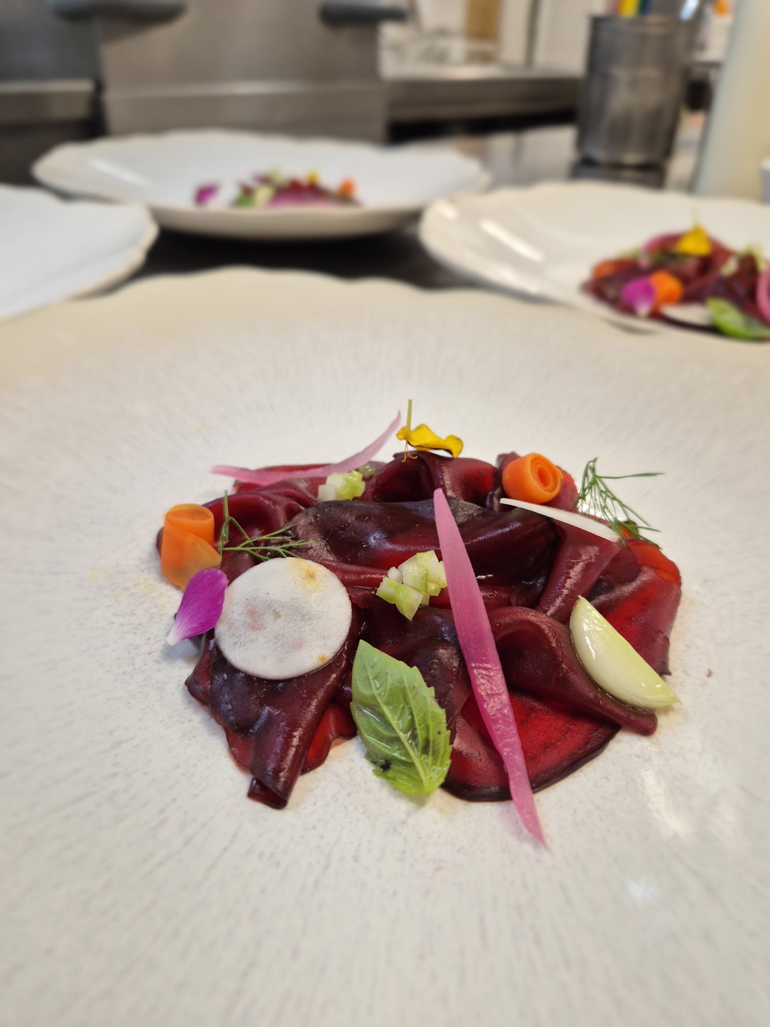 Dishes with vegetables and flowers, ready on the kitchen counter